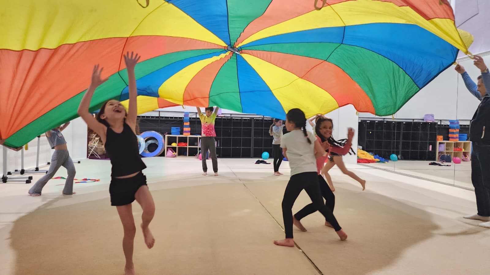Campers laughing and reaching up during an active group game